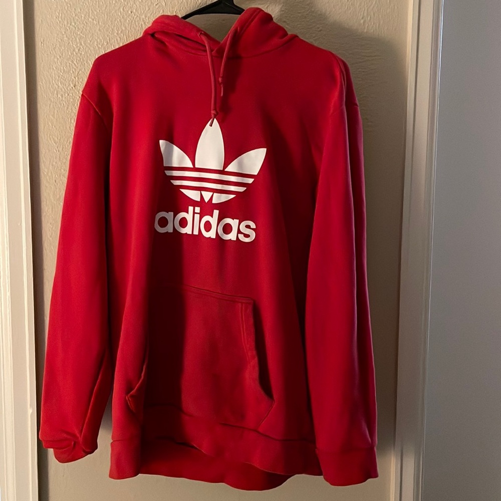 Red and white hoodie, gently used. Brand is adidas’s
